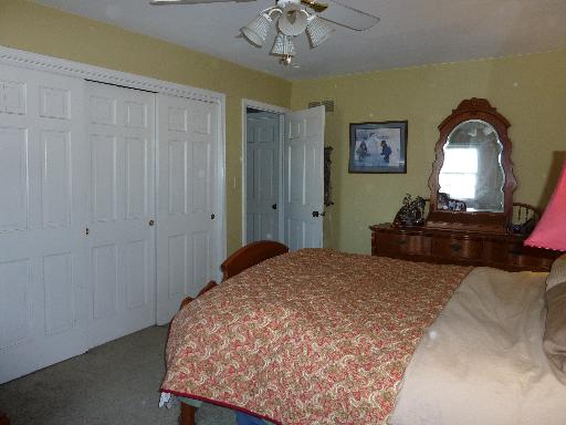 1N679 Harley Road Elburn, IL 60119 - Photo 9 of 16 a bedroom with a bed and a chandelier