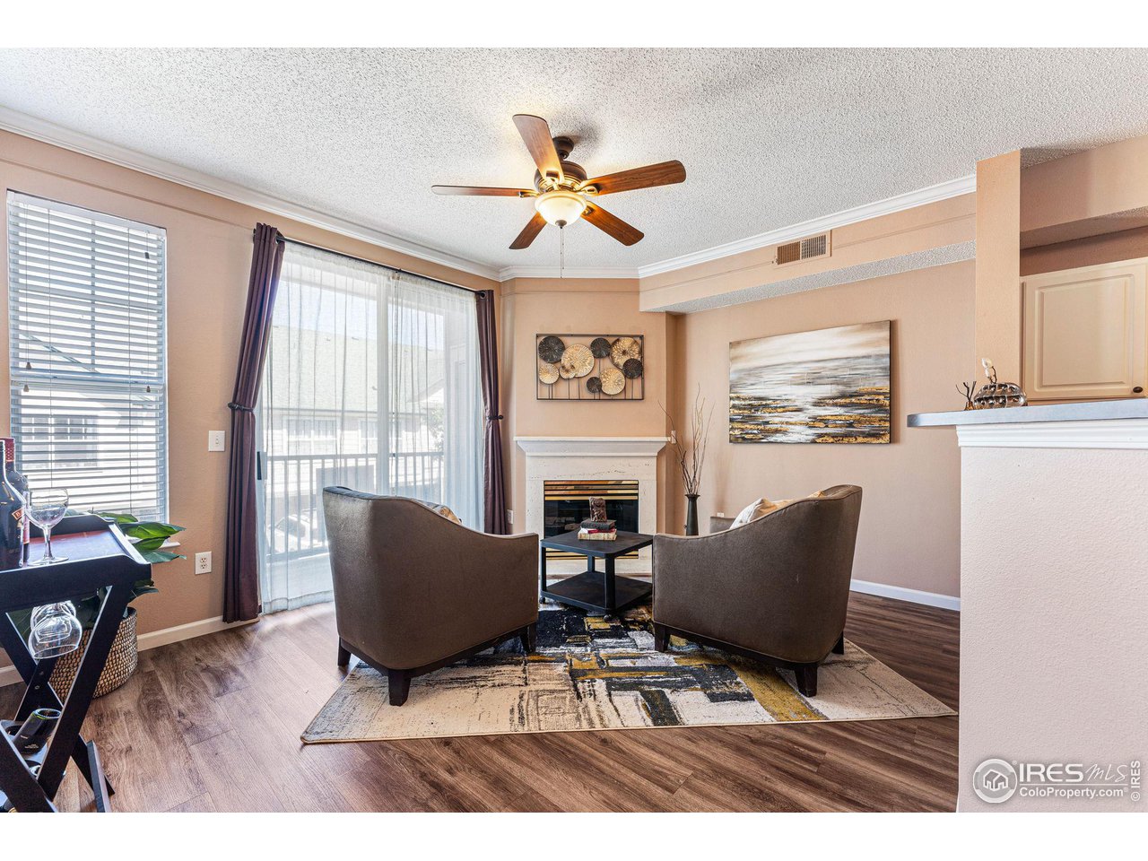 a living room with furniture a fireplace and a window