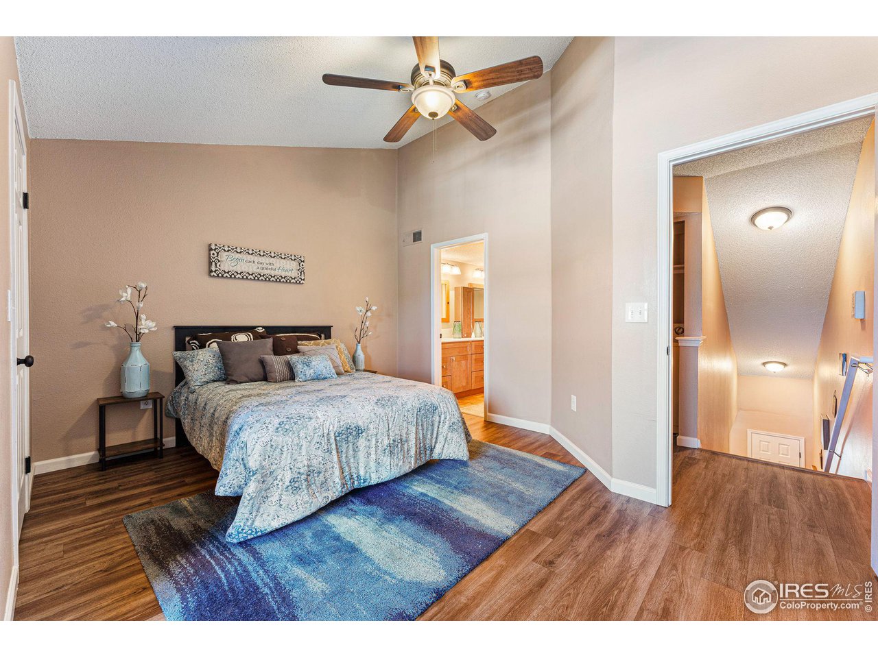 1839 Spaulding Circle Superior, CO 80027 - Photo 15 of 27 a bedroom with a bed and wooden floor