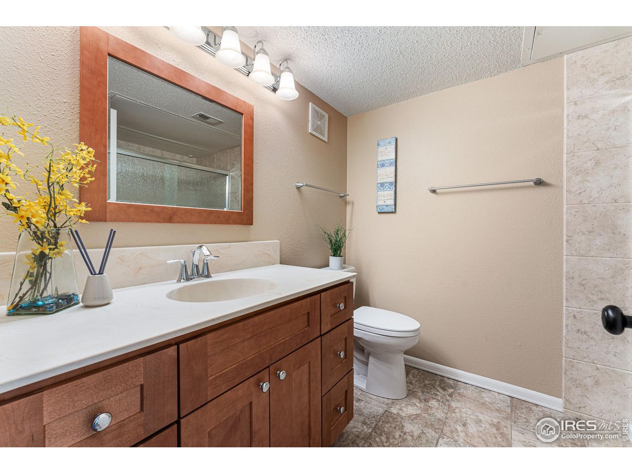 1839 Spaulding Circle Superior, CO 80027 - Photo 17 of 27 a bathroom with a granite countertop sink toilet and mirror