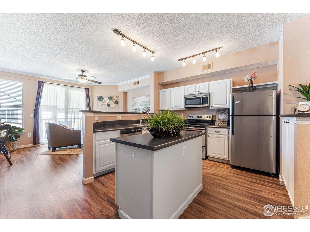 1839 Spaulding Circle Superior, CO 80027 - Photo 5 of 27 a kitchen with granite countertop a refrigerator and a stove top oven