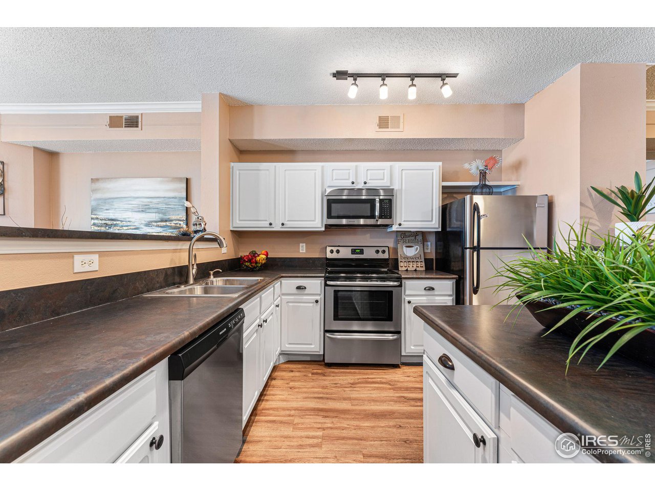 1839 Spaulding Circle Superior, CO 80027 - Photo 8 of 27 a kitchen with stainless steel appliances granite countertop a sink stove and refrigerator
