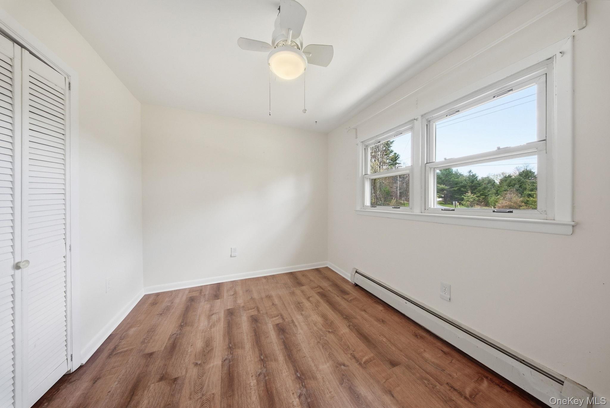 87 Airport Road Eldred, NY 12732 - Photo 14 of 30 wooden floor in an empty room with a window