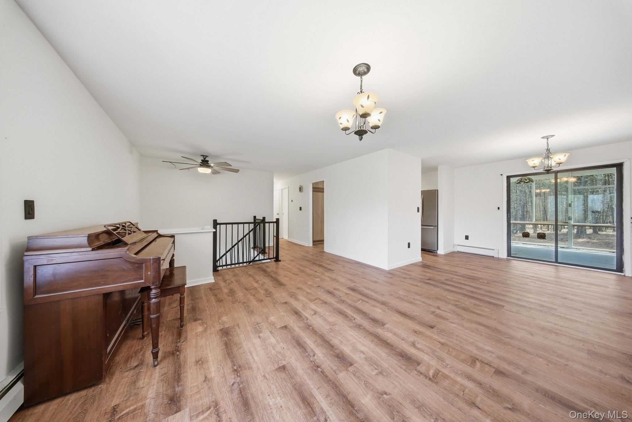 87 Airport Road Eldred, NY 12732 - Photo 19 of 30 a view of a room with wooden floor and ceiling fan