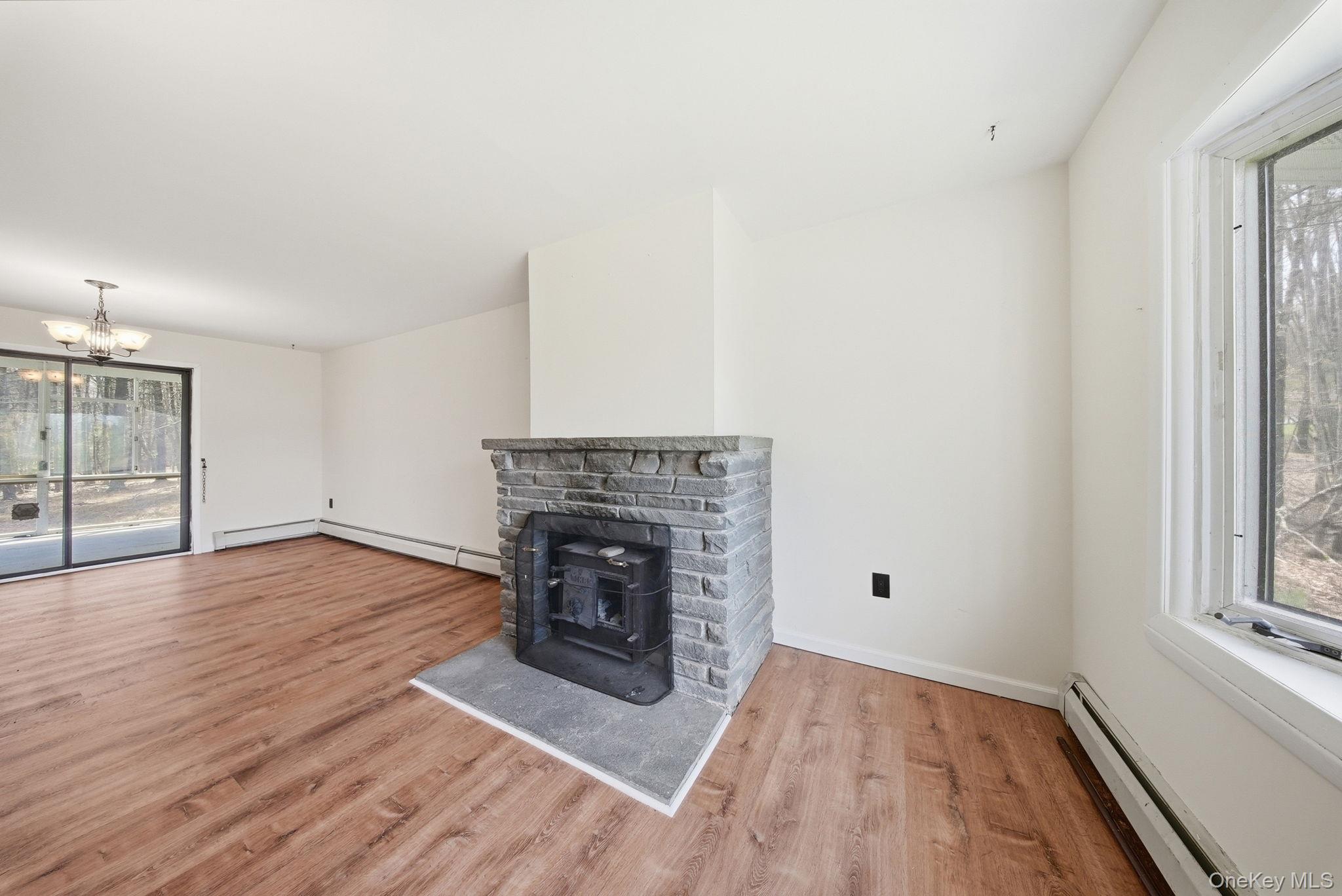 87 Airport Road Eldred, NY 12732 - Photo 20 of 30 a view of empty room with wooden floor and fireplace