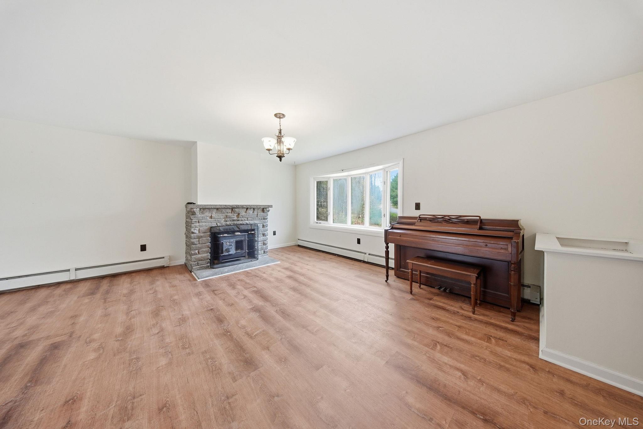 87 Airport Road Eldred, NY 12732 - Photo 8 of 30 a view of empty room with fireplace and wooden floor