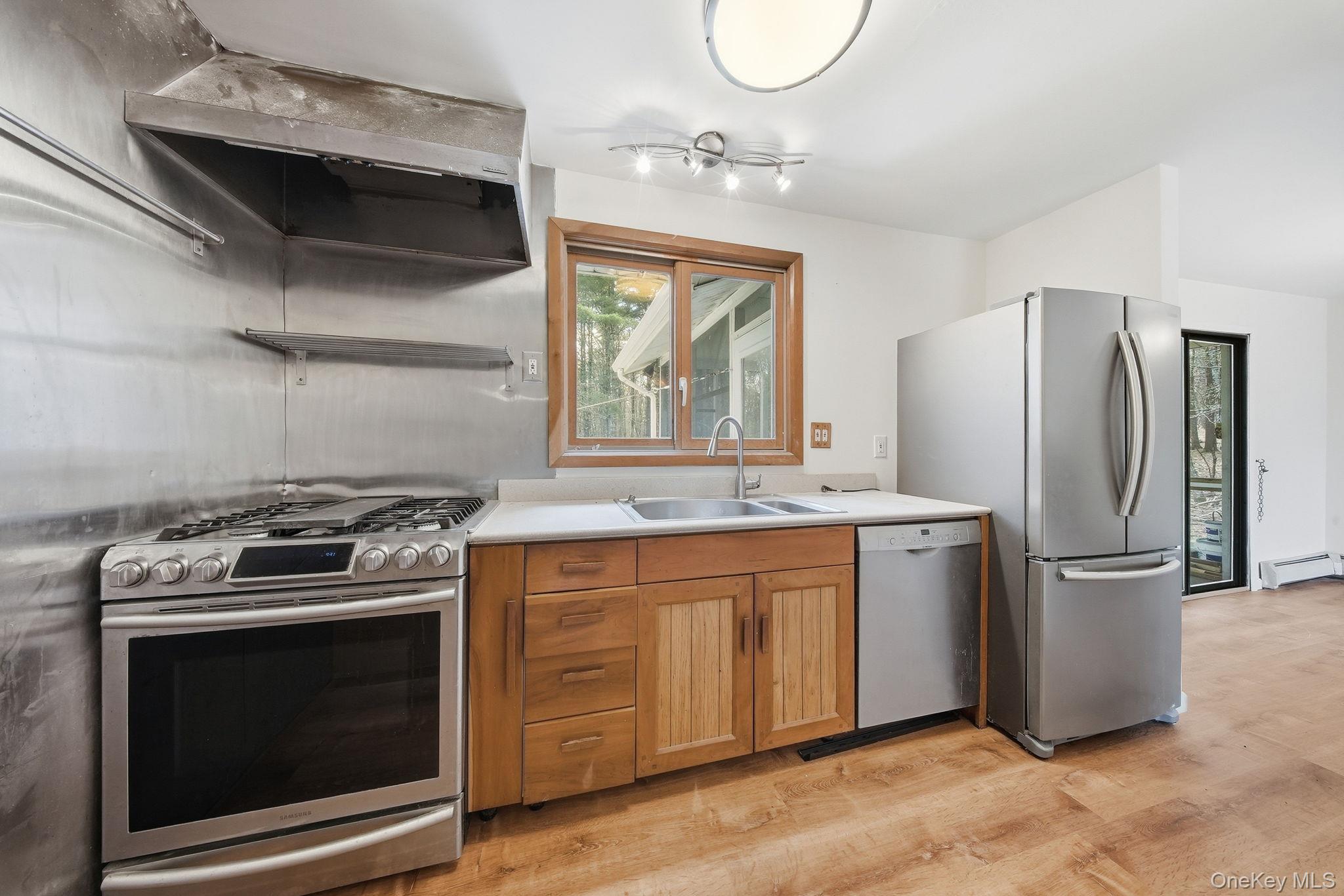 87 Airport Road Eldred, NY 12732 - Photo 9 of 30 a kitchen with granite countertop a stove and a refrigerator