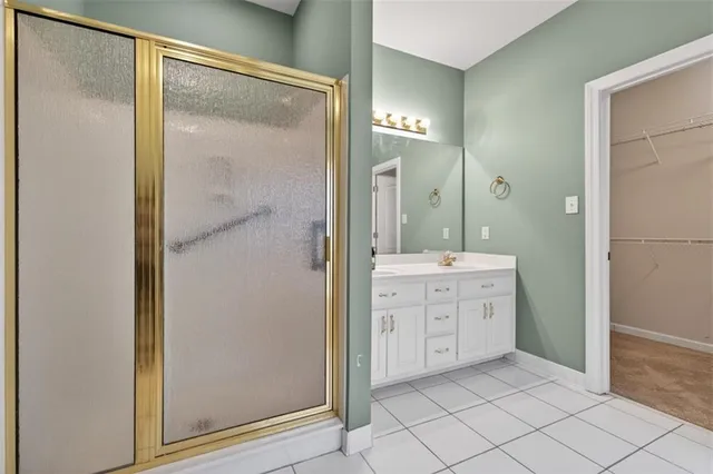a bathroom with a shower sink and mirror