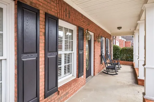 a view of living room and porch with furniture