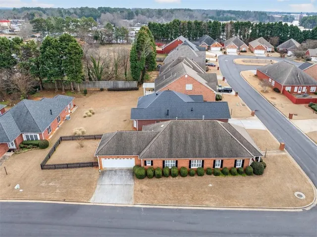 an aerial view of a house with a yard