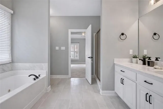 a bathroom with a tub sink and mirror