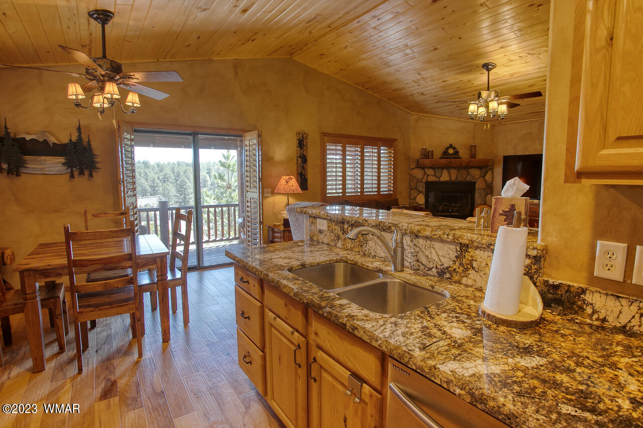 1911 North Bison Ridge Trail, Unit 10 Show Low, AZ 85901 - Photo 7 of 17 a kitchen with sink refrigerator and dining table
