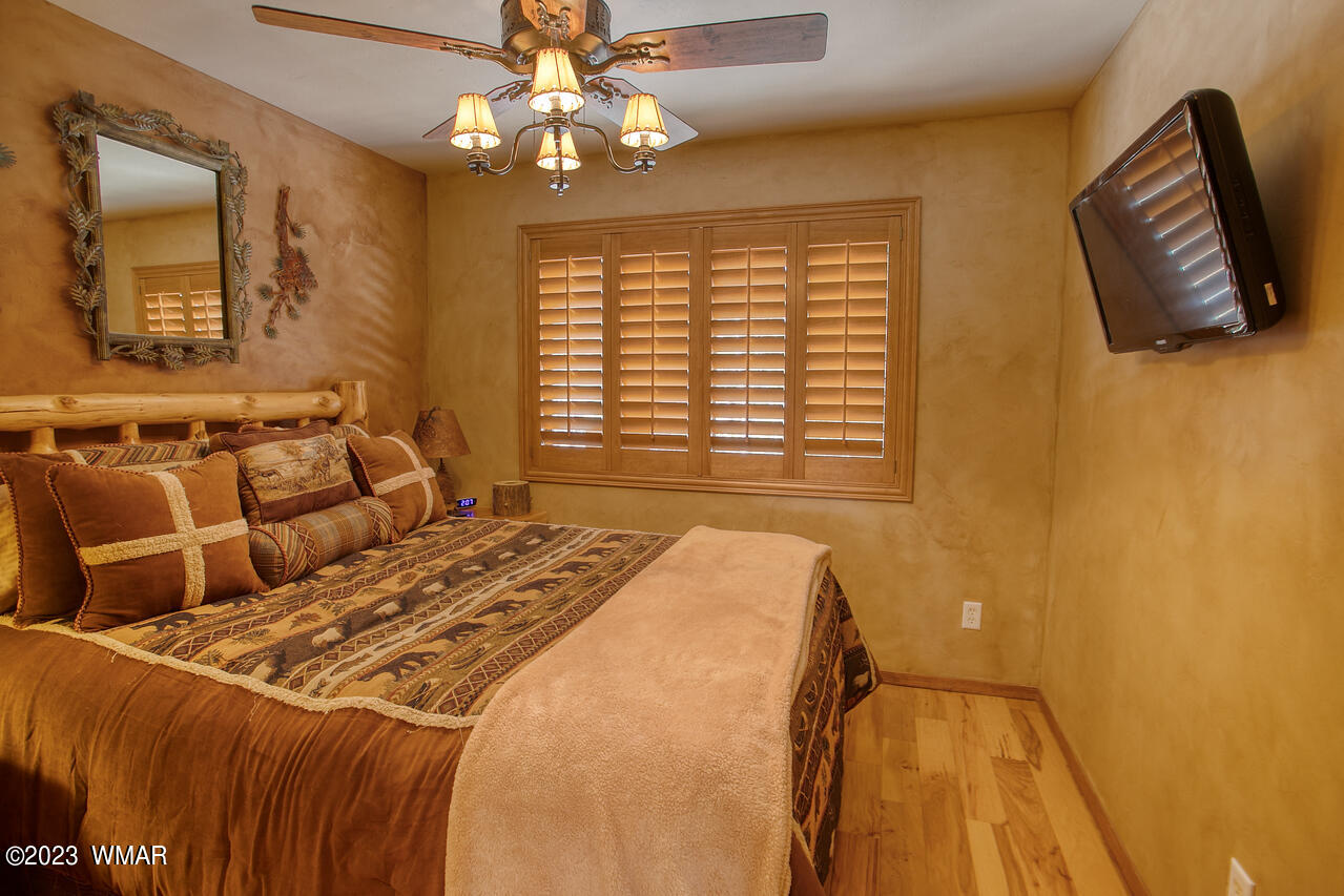 1911 North Bison Ridge Trail, Unit 10 Show Low, AZ 85901 - Photo 10 of 17 a bed sitting in a bedroom next to a window