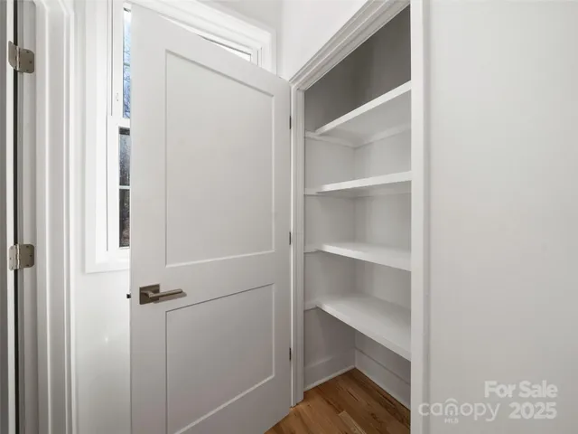 a view of walk in closet with empty racks
