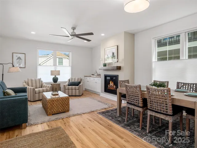 a living room with furniture a fireplace and a table