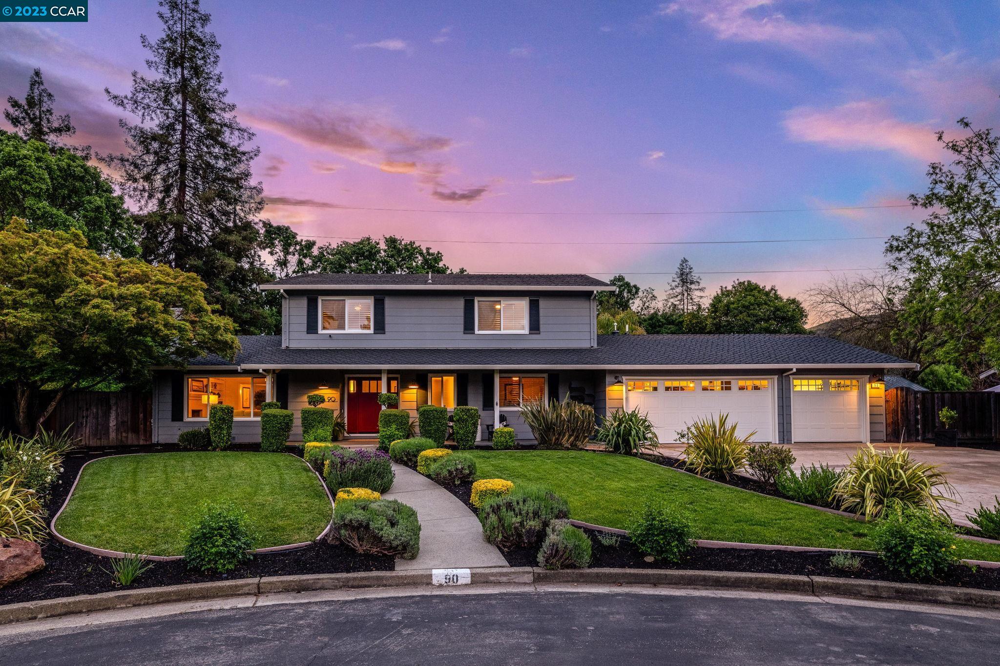 a front view of a house with garden