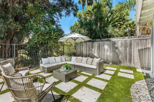 a view of a patio with couches chairs and a fire pit
