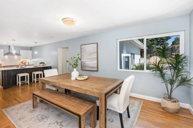 a view of a dining room with furniture and a potted plant