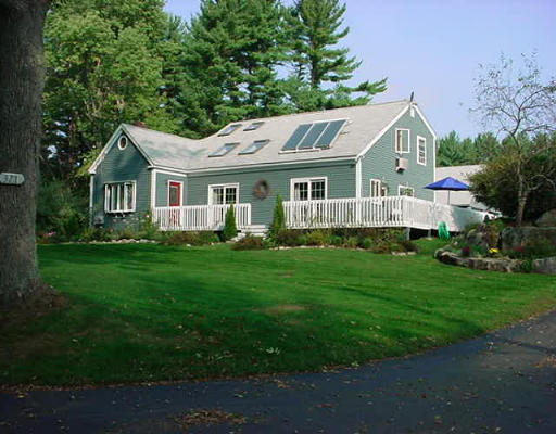 371 Taylor Road Stow, MA 01775 - Photo 1 of 1 a front view of house with yard and green space