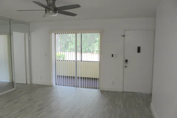 a kitchen with a sink cabinets and wooden floor