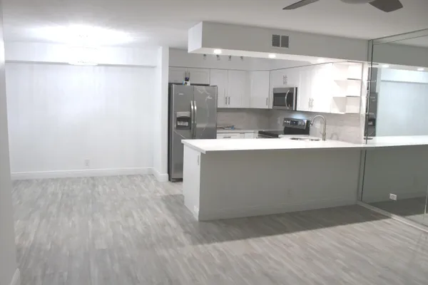 a kitchen with a sink and a stove top oven