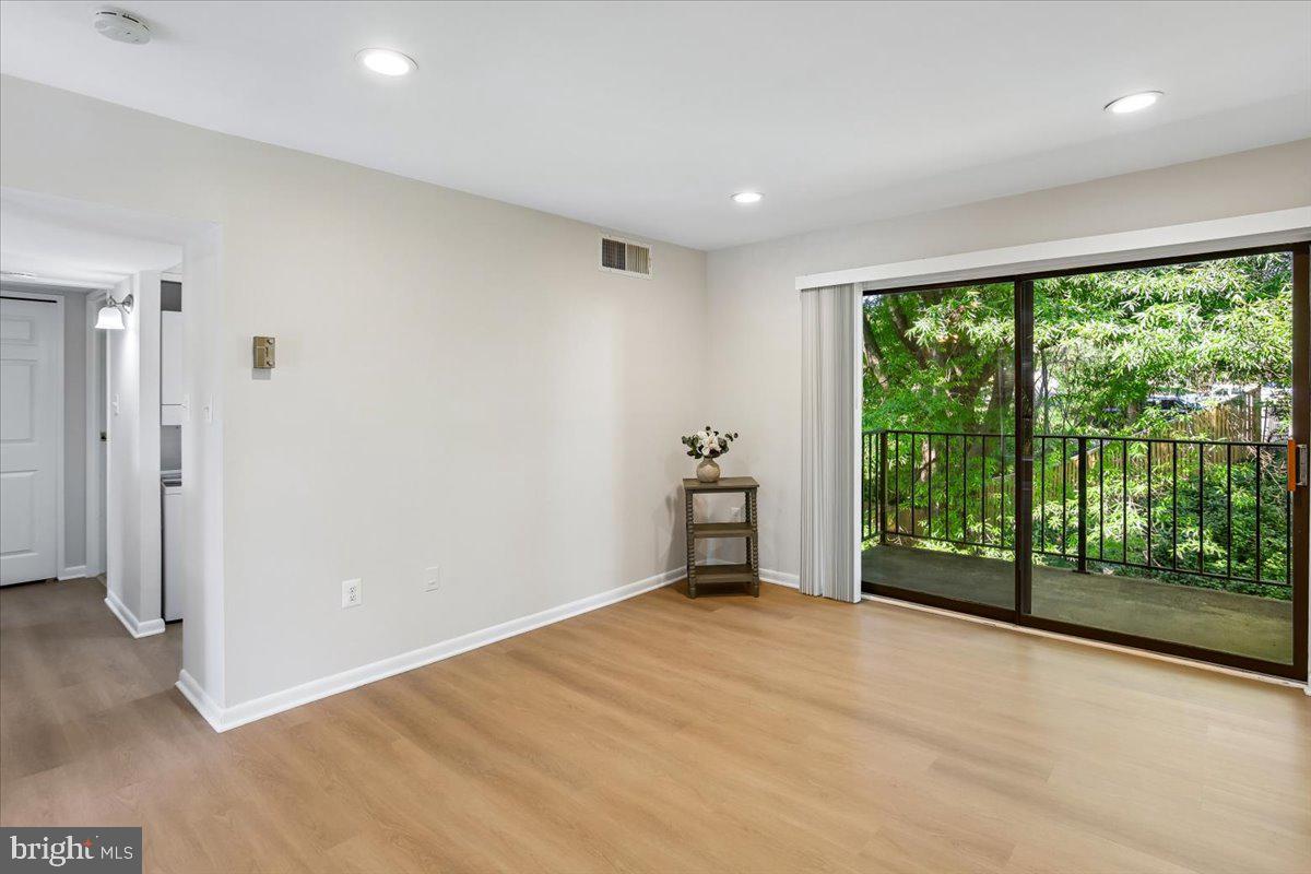 17804 Buehler Road, Unit 3D3 Olney, MD 20832 - Photo 3 of 32 a view of an empty room with wooden floor and a balcony