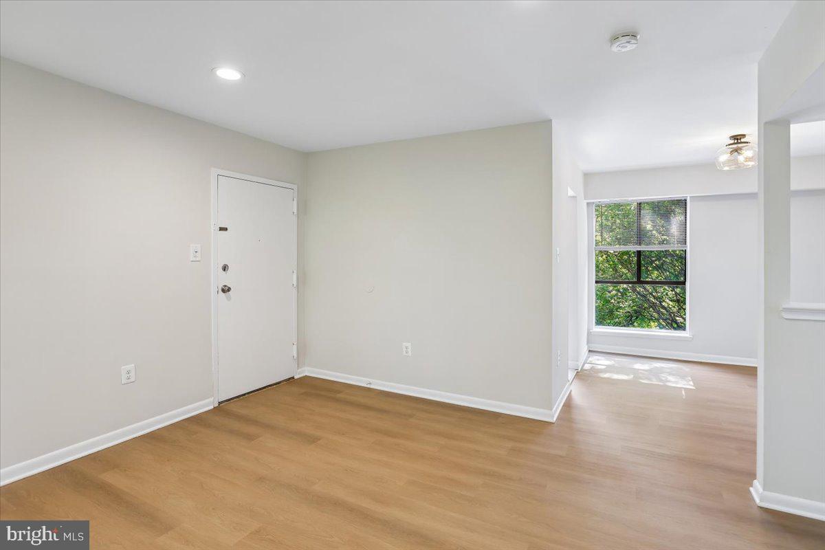 17804 Buehler Road, Unit 3D3 Olney, MD 20832 - Photo 6 of 32 a view of an empty room with wooden floor and a window