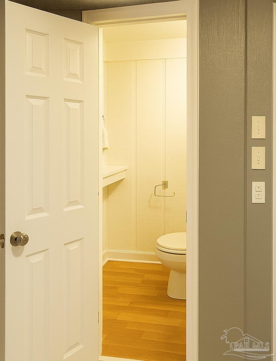 6274 Munson Highway Milton, FL 32570 - Photo 13 of 26 a bathroom with a granite countertop toilet and a shower