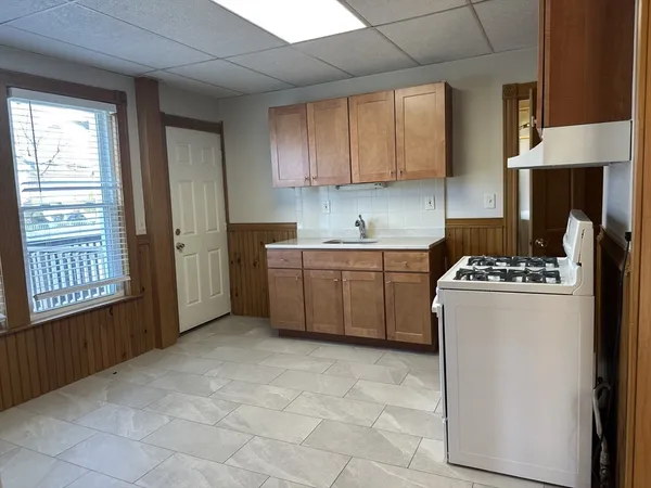 a kitchen with a stove a sink dishwasher and a refrigerator