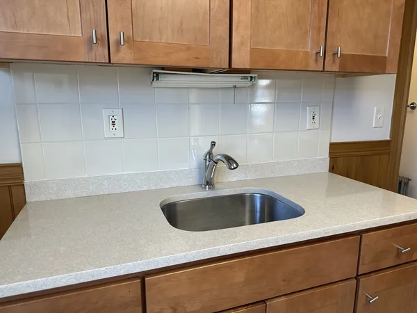a close view of sink and cabinets
