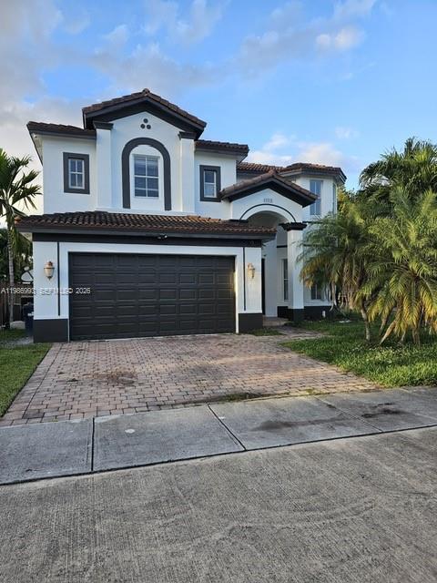11151 Southwest 241st Street Homestead, FL 33032 - Photo 1 of 18 a front view of a house with a yard and garage