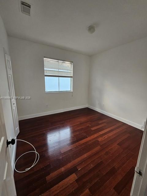 11151 Southwest 241st Street Homestead, FL 33032 - Photo 12 of 18 a room with wooden floor and window