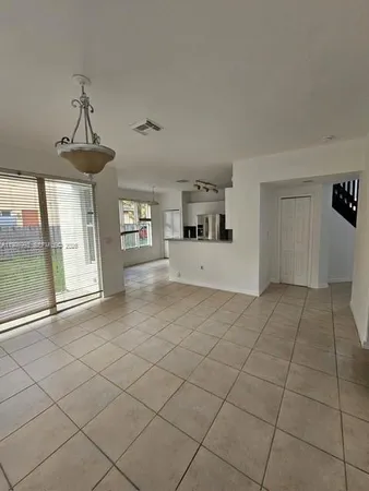 a view of a livingroom with a furniture chandelier and window