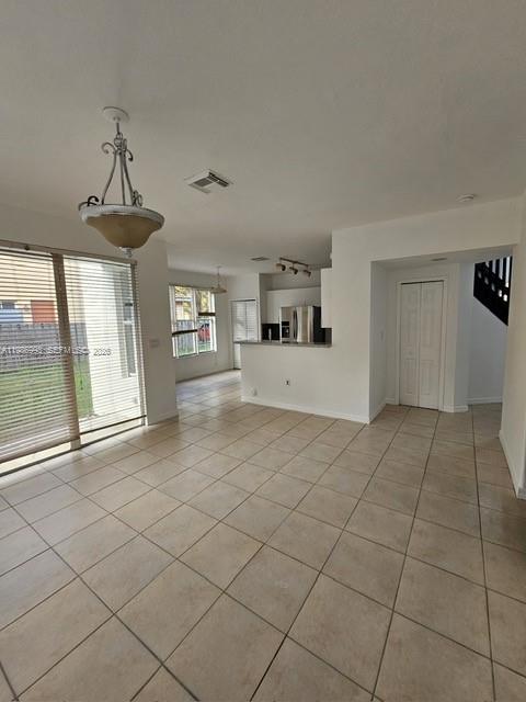 11151 Southwest 241st Street Homestead, FL 33032 - Photo 7 of 18 a view of a livingroom with a furniture chandelier and window