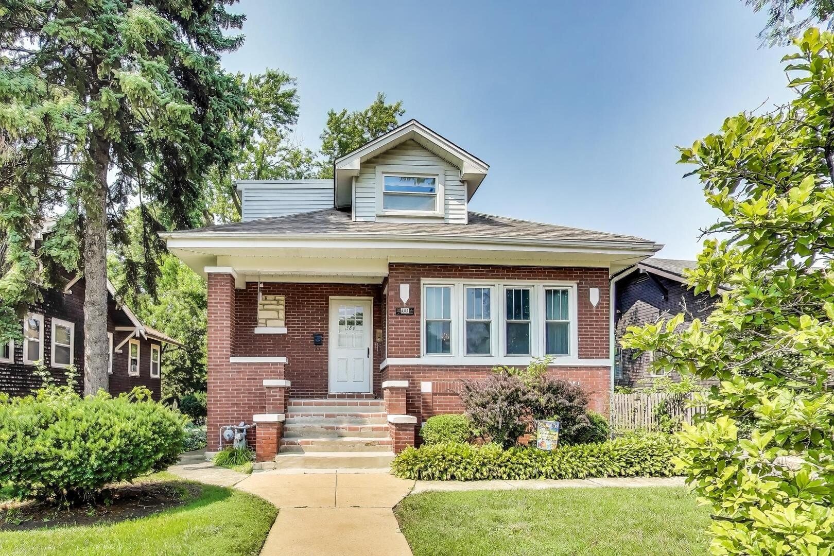 284 Addison Road Riverside, IL 60546 - Photo 1 of 44 a front view of a house with garden