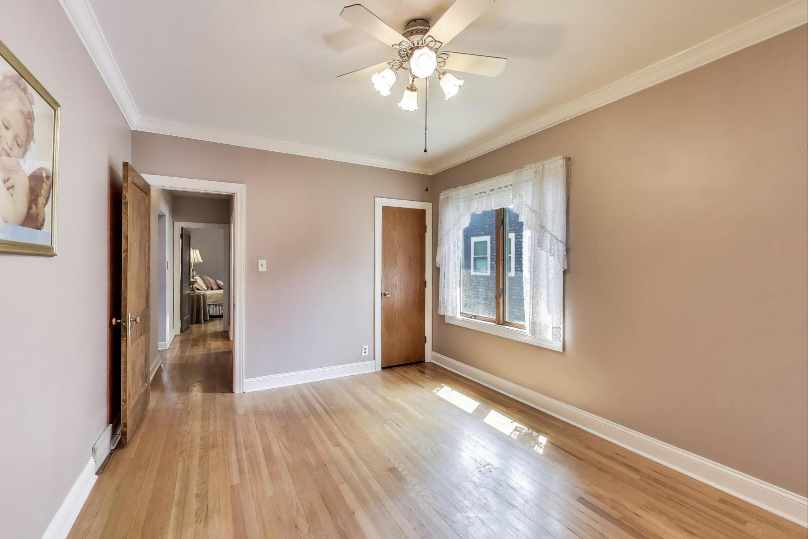 284 Addison Road Riverside, IL 60546 - Photo 17 of 44 a view of an empty room with window and wooden floor