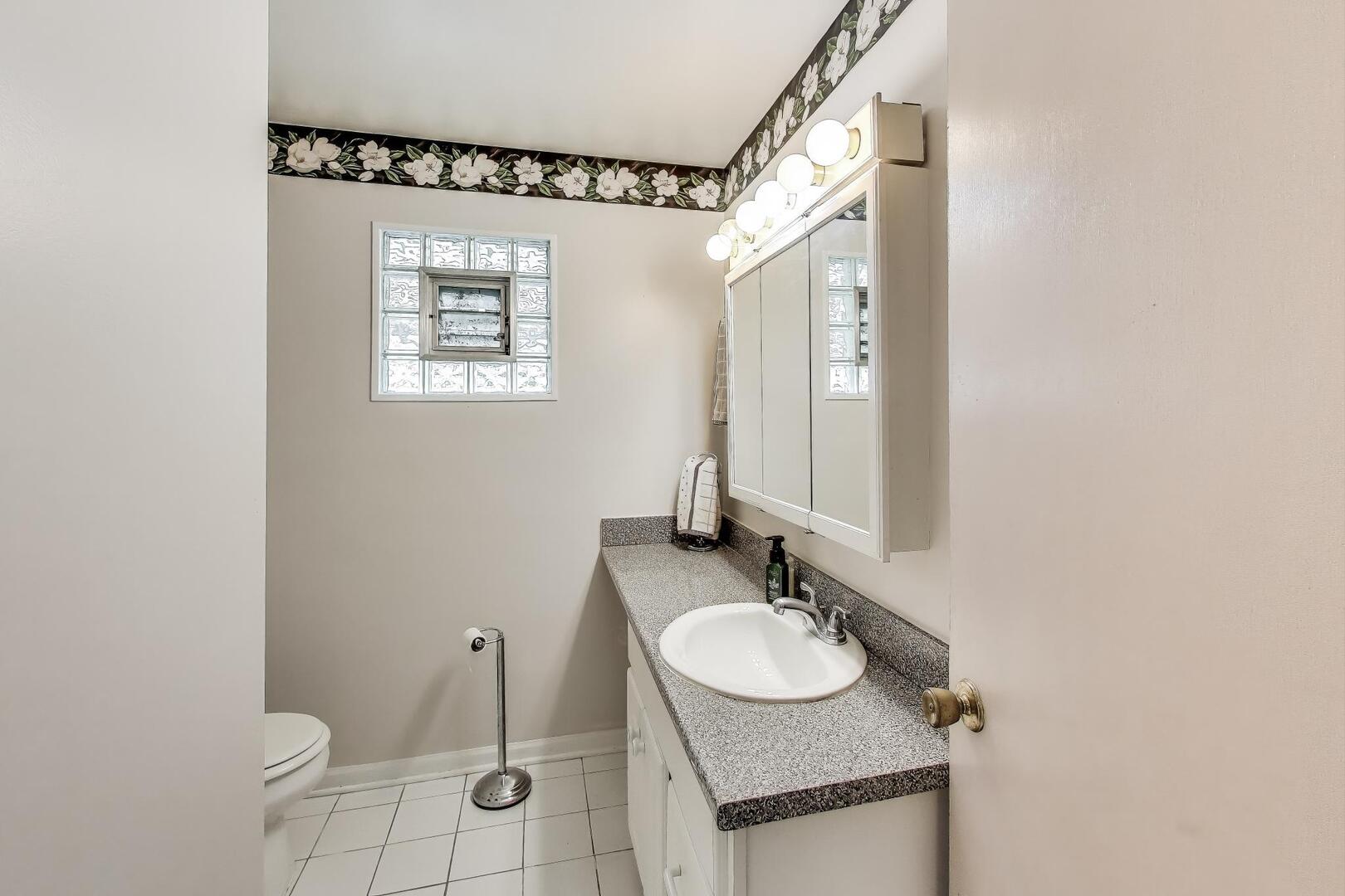284 Addison Road Riverside, IL 60546 - Photo 28 of 44 a bathroom with a granite countertop sink and a mirror