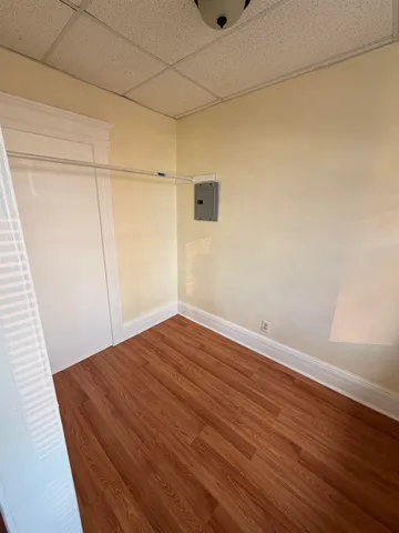 a view of a room with wooden floor