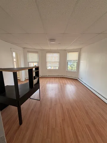 a view of a livingroom with furniture and hardwood floor