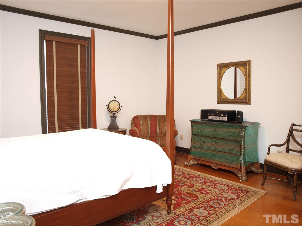2326 Hales Road Raleigh, NC 27608 - Photo 8 of 21 a bedroom with a bed and wooden floor