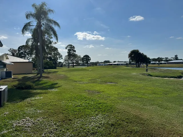 a yard with lots of green space and trees