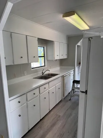a kitchen with sink cabinets and window