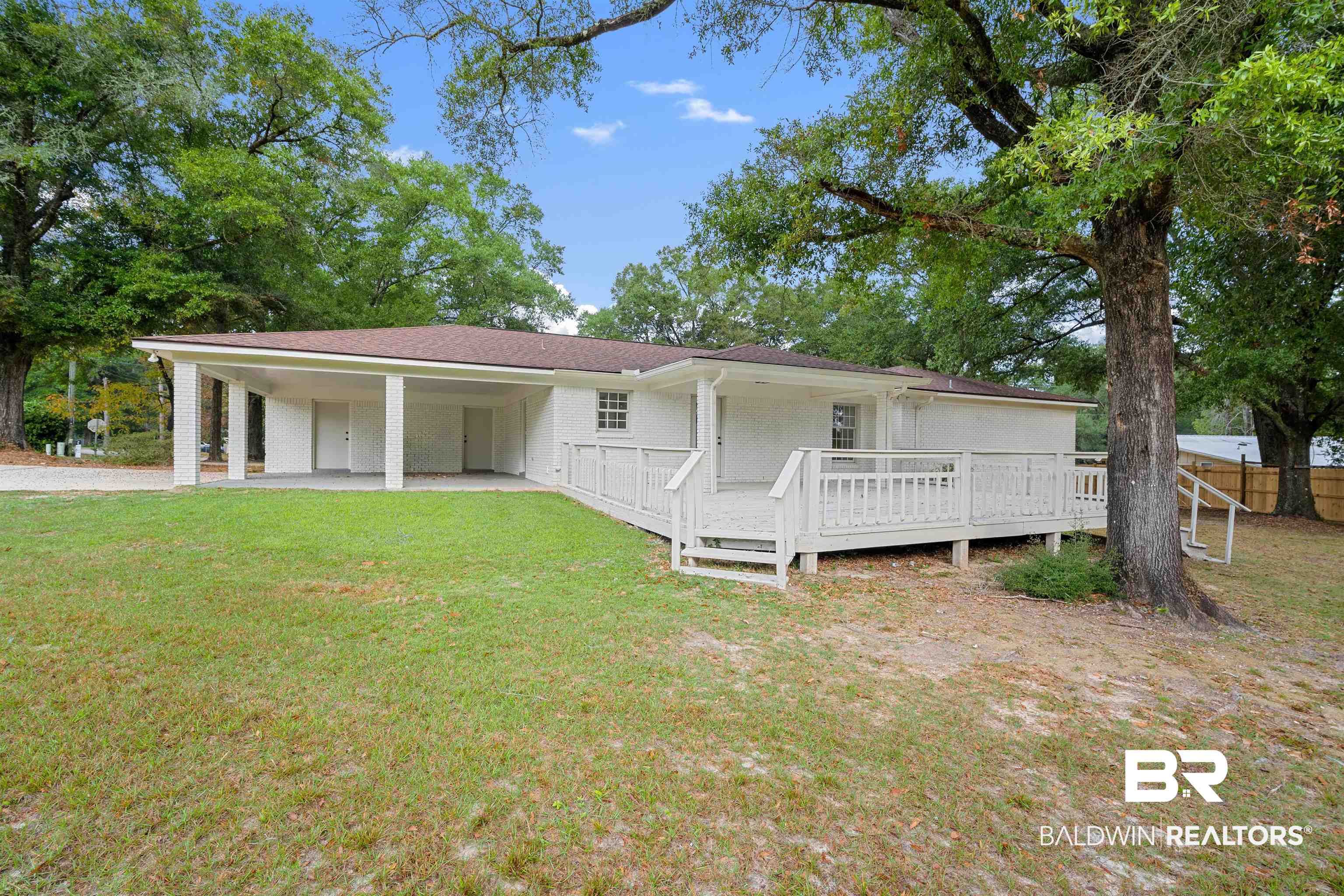 3050 Lacoste Road Mobile, AL 36618 - Photo 28 of 30 View of front of property featuring an attached carport, a deck, and roof with shingles