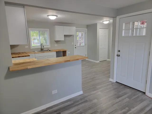 a kitchen with granite countertop a stove and cabinets