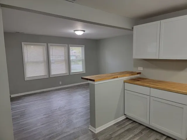 a view of storage and utility room with wooden floor