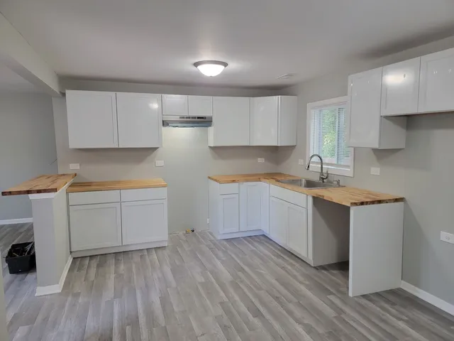 a kitchen with granite countertop a sink and a stove top oven
