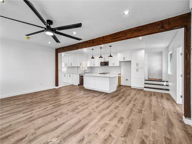 a view of a kitchen with a sink and a refrigerator