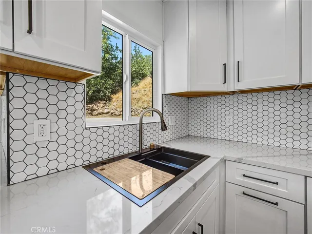 a kitchen with a stove and a window