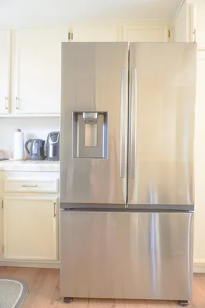a kitchen with a refrigerator and cabinets
