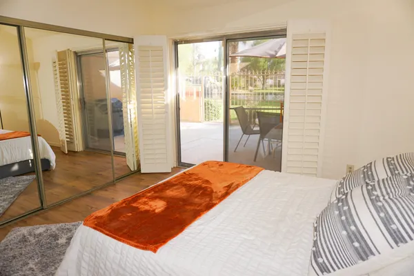 a bedroom with a bed and glass door